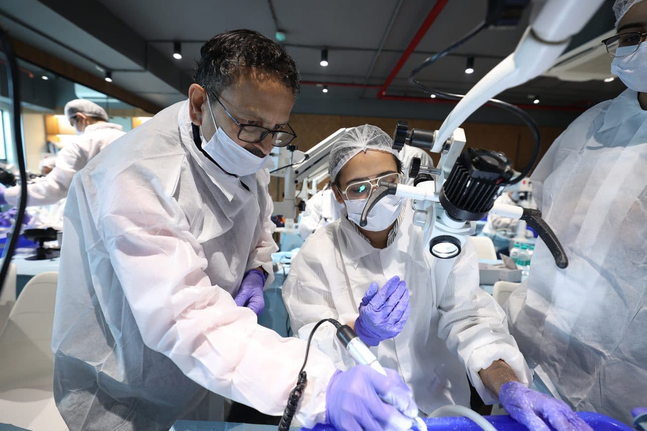 Faculty guiding a delegate during hands-on dissection